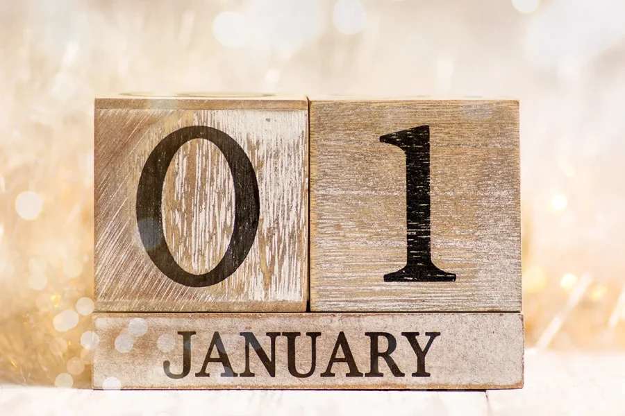 A calendar displaying the date as 1st January with festive background and Christmas lights