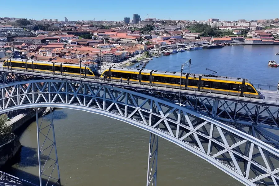 A train crosses Dom Luis I bridge over the Douro river in Porto, Portugal.